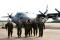 Members of the flight crew for the final flight of C-130E 61-2358 on 1 May 2012 walk from the aircraft to the retirement ceremony after completing their pre-flight checks. The augmented crew on the flight consisted of Maj. Brad Salmi (pilot), Lt. Justin Pedone (copilot), Lt. Col. Dennis King (navigator and commander of the 61st Airlift Squadron), MSgt. Michael Sowden (engineer), CMSgt. Sam Frederick (loadmaster); and A1C Alicia Wegman (loadmaster), as well as TSgt. Bobby Jones (crew chief), and SSgt. Joshua Dunkin (flying crew chief).