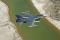 An F-16 Fighting Falcon from the 416th Flight Test Squadron from Edwards AFB, California, flies over Koehn Lake in the Mojave Desert.